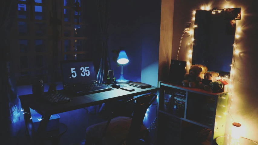 a laptop computer sitting on top of a wooden desk, a picture, inspired by Elsa Bleda, dark bedroom, blue: 0.5, instagram picture, late night