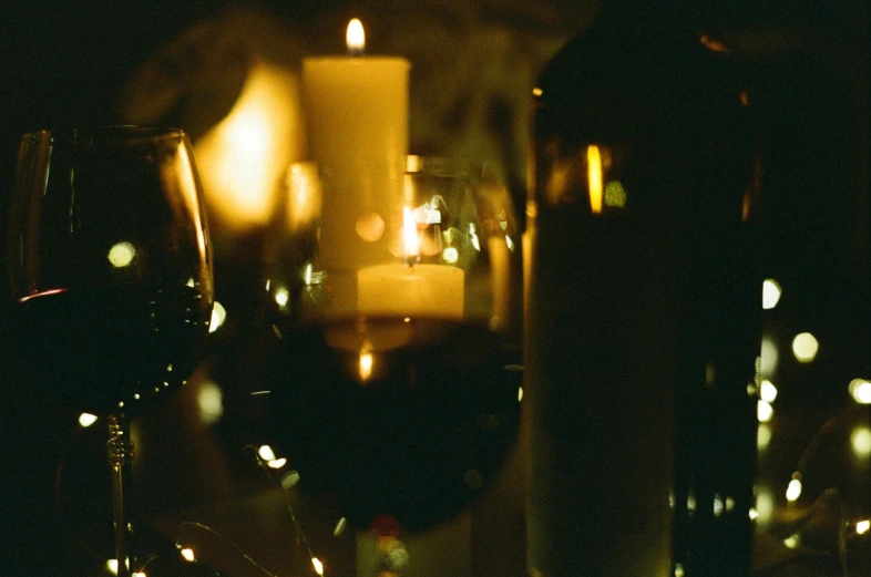 a candle and some wine glasses on a table, pexels contest winner, grainy, middle close up, single light, amanda lilleston