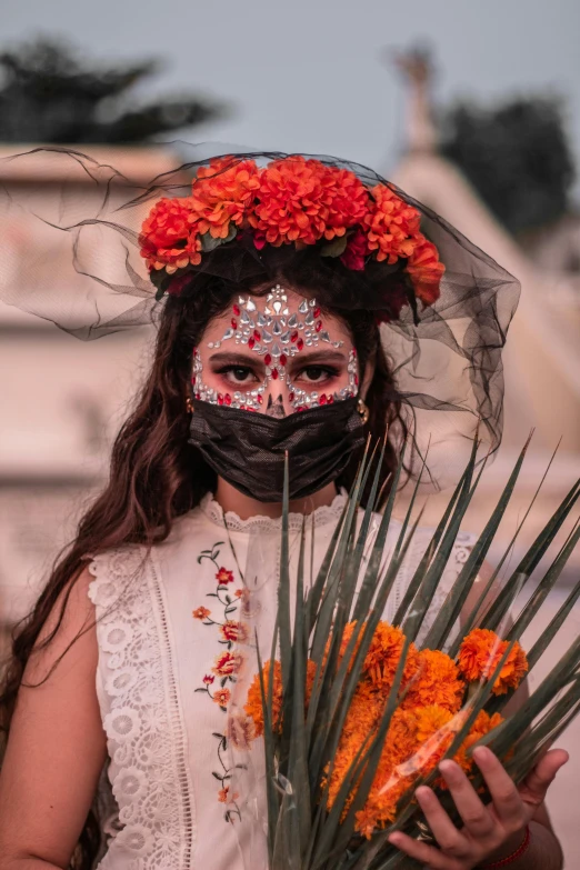 a woman wearing a mask and holding a bunch of flowers, inspired by Frida Kahlo, pexels contest winner, renaissance, black and orange, isabela moner, bride, mexico city