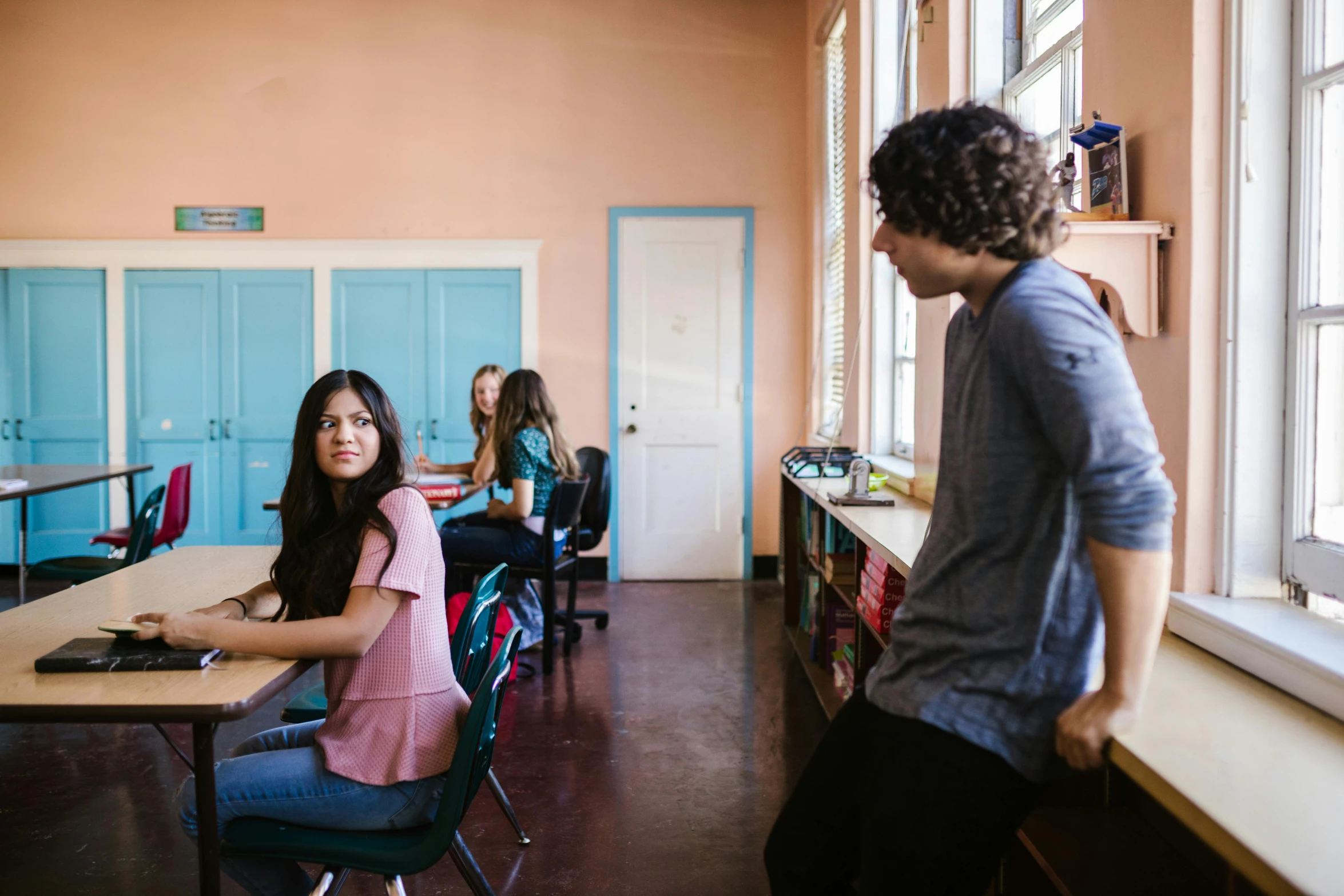 a group of people sitting at desks in a room, by Anna Findlay, trending on unsplash, ashcan school, two buddies sitting in a room, standing in class, natural light outside, lorena avarez