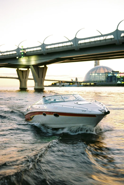 a speed boat going under a bridge on the water, skyline, taken in the late 2000s, fan favorite, ergonomic