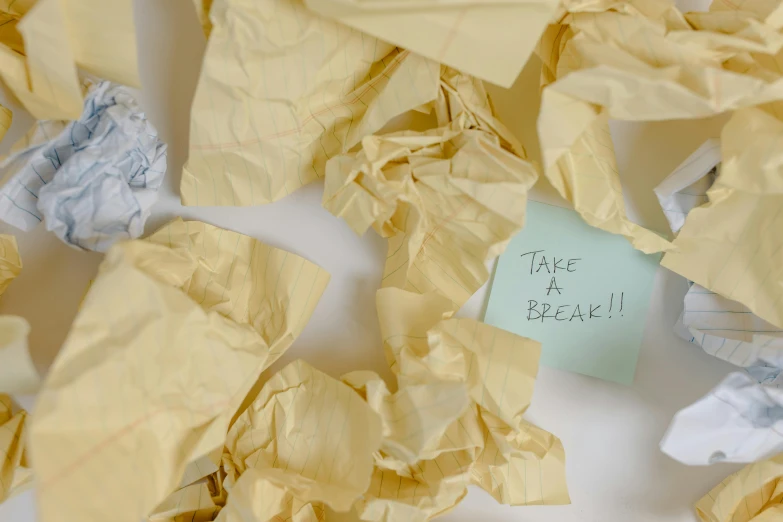 a pile of crumpled paper with a note that says take a break, pexels, happening, beige, thumbnail, tape, messy bedroom