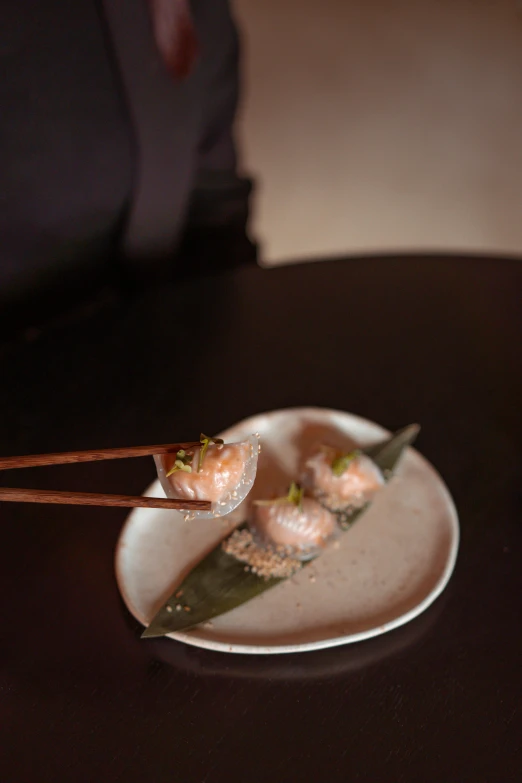 a close up of a plate of food with chopsticks, at night, sitting down, symetrical japanese pearl, grey