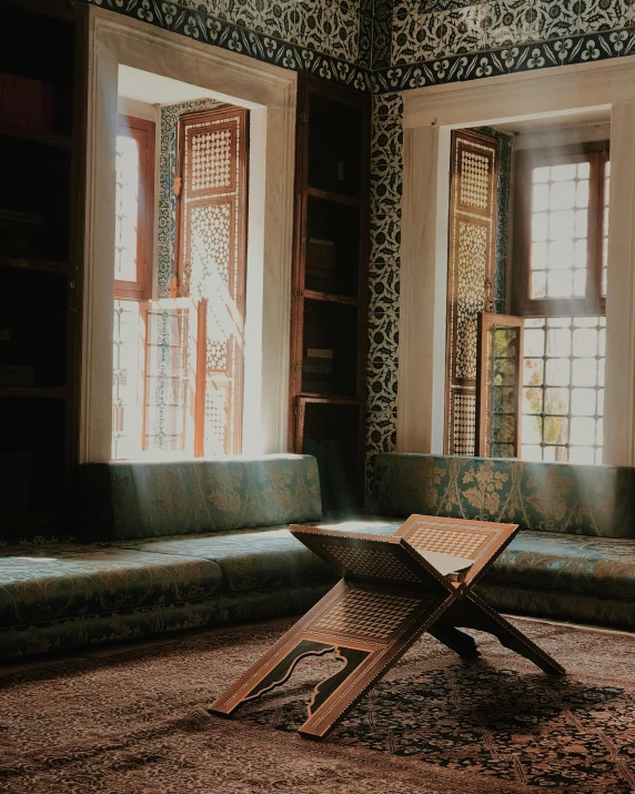 a chair sitting on top of a rug in a living room, by Riad Beyrouti, pexels contest winner, hurufiyya, old library, window light, cybermosque interior, green and brown color palette