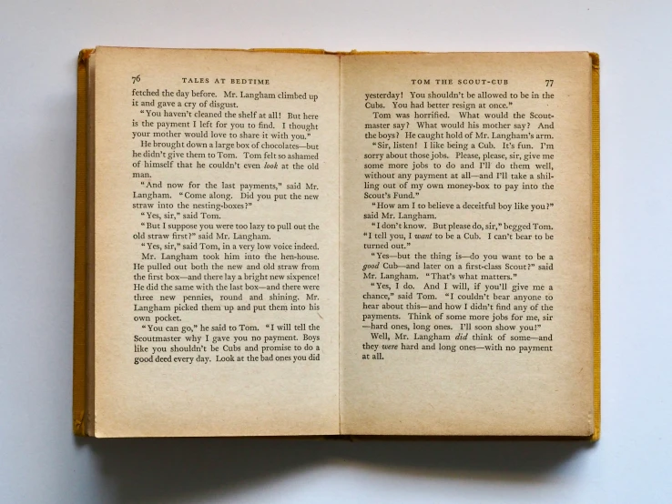 an open book sitting on top of a table, english text, mid-30s, two stories, old book