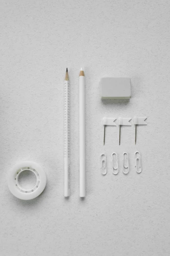 a pair of scissors sitting on top of a white table, kit, pencil and paper, white: 0.5, grey