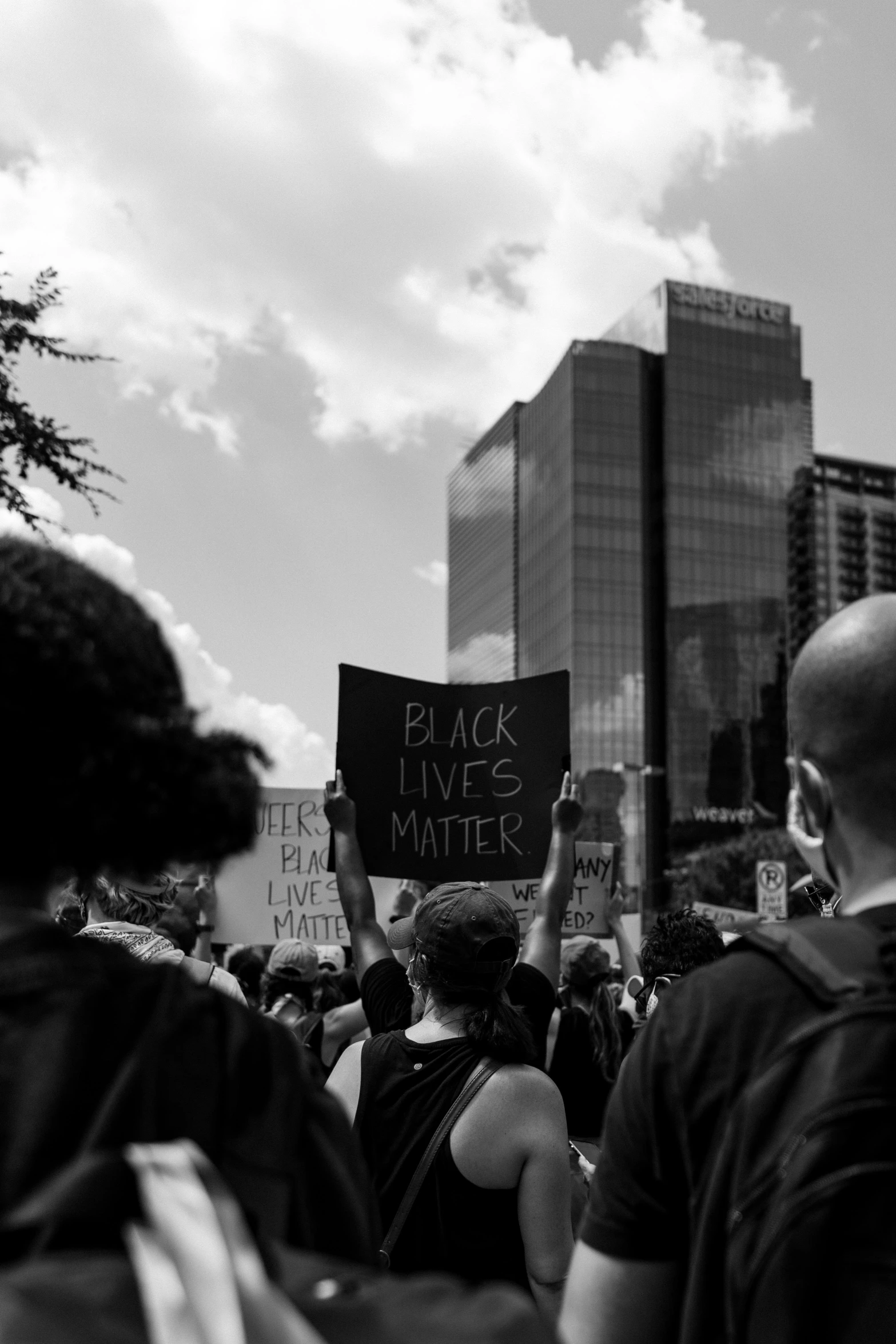 a group of people walking down a street holding signs, a black and white photo, by Charles Martin, unsplash contest winner, black arts movement, and burbled as it came, a person standing in front of a, bl, filled with people