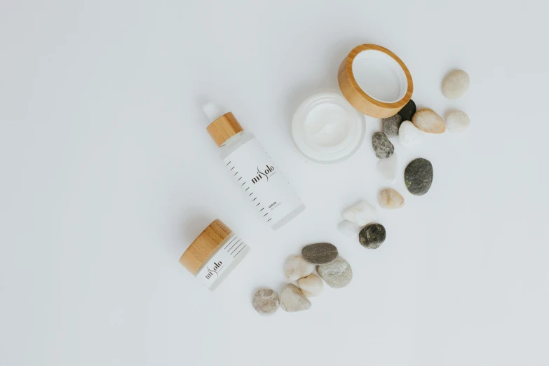 various skin care products laid out on a white surface, by Arabella Rankin, unsplash, dau-al-set, bamboo, on textured base; store website, product view, twinkling and spiral nubela