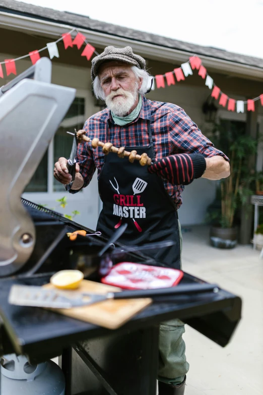 a man standing in front of a grill with food on it, overalls and a white beard, gmaster, dutch masters, thumbnail