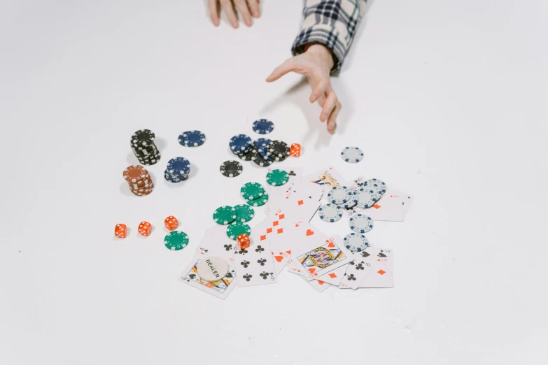 a person sitting at a table with playing cards and chips, an album cover, by Gavin Hamilton, pexels contest winner, set against a white background, pixel sorting, [ overhead view of a table ]!!, varying dots