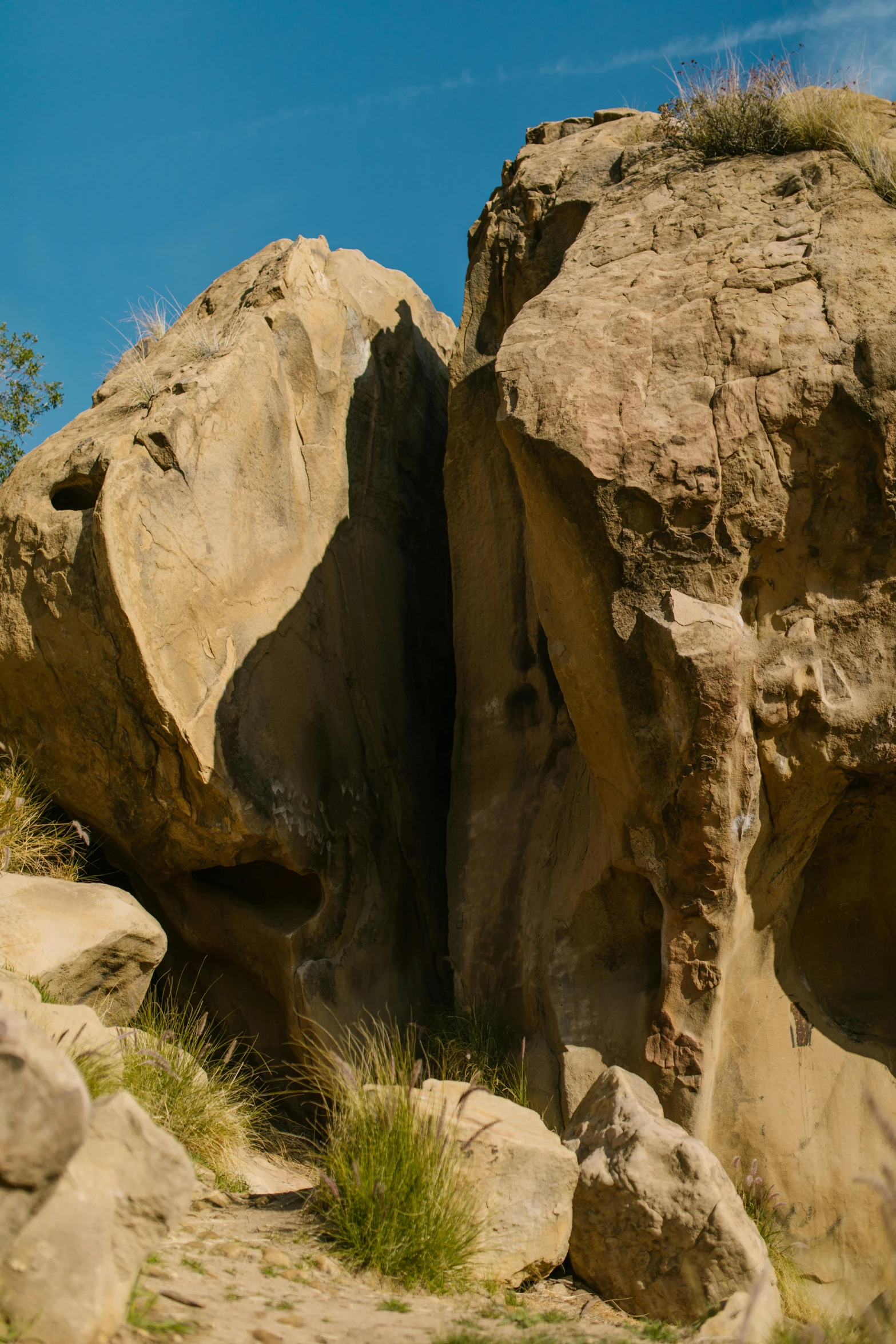 a man riding a skateboard on top of a rocky hill, a cave painting, by Peter Churcher, unsplash, palm springs, tall big rocks, ((rocks)), panoramic shot