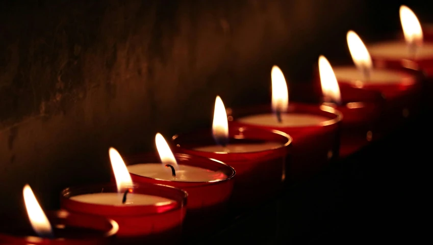 a row of red candles sitting next to each other, lynn skordal, multiple stories, evening light, deep colour