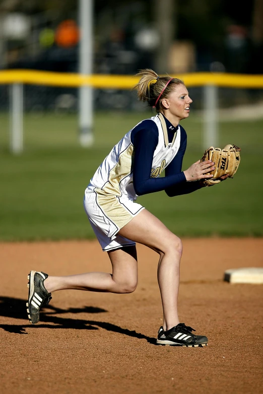 a woman wearing a catchers mitt on a baseball field, a picture, pretty face with arms and legs, biomechanics, gold, navy