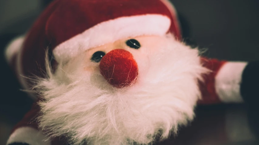 a close up of a santa claus doll on a table, pexels contest winner, cute nose, thumbnail, plushy, grainy