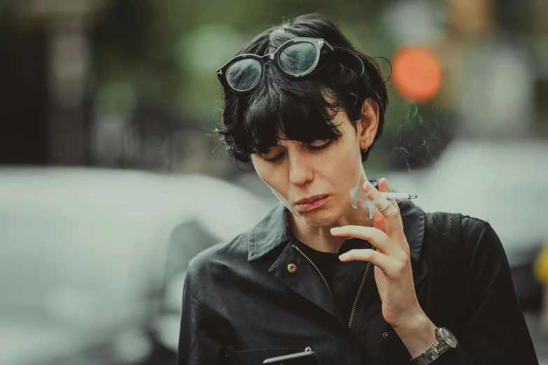 a woman smoking a cigarette on a city street, an album cover, inspired by Elsa Bleda, pexels contest winner, bauhaus, black short hair, biker, sarah andersen, hyper-realism