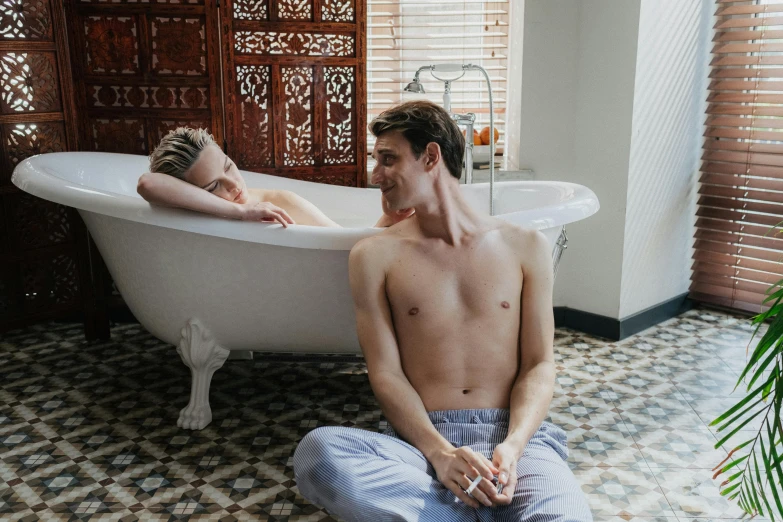 a man and a woman sitting in a bathtub, unsplash, two buddies sitting in a room, lachlan bailey, androgynous male, paradise garden massage