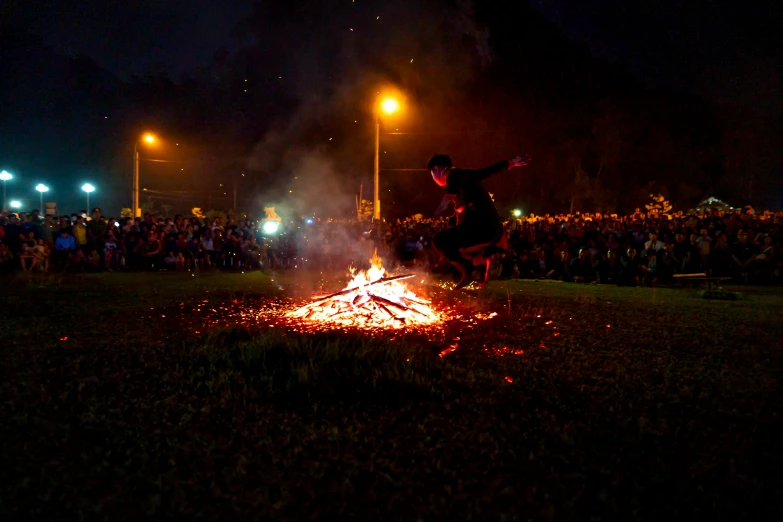 a man riding a skateboard on top of a fire, community celebration, lots of embers, lachlan bailey, university