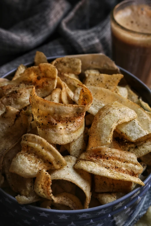 a bowl filled with chips next to a cup of coffee, inspired by Pia Fries, renaissance, dried plants, medium close shot, uttarakhand, banana