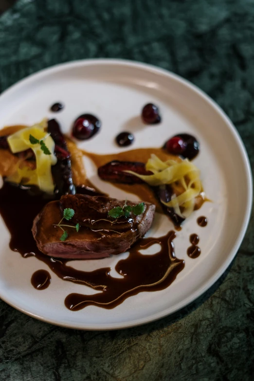 a white plate topped with meat covered in sauce, by Jay Hambidge, pexels contest winner, renaissance, duck, caramel, dark and dim, carved