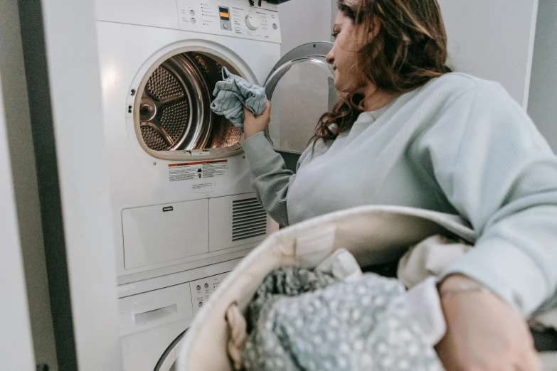 a woman standing in front of a washing machine, pexels contest winner, alana fletcher, worksafe. instagram photo, profile image, woman holding another woman