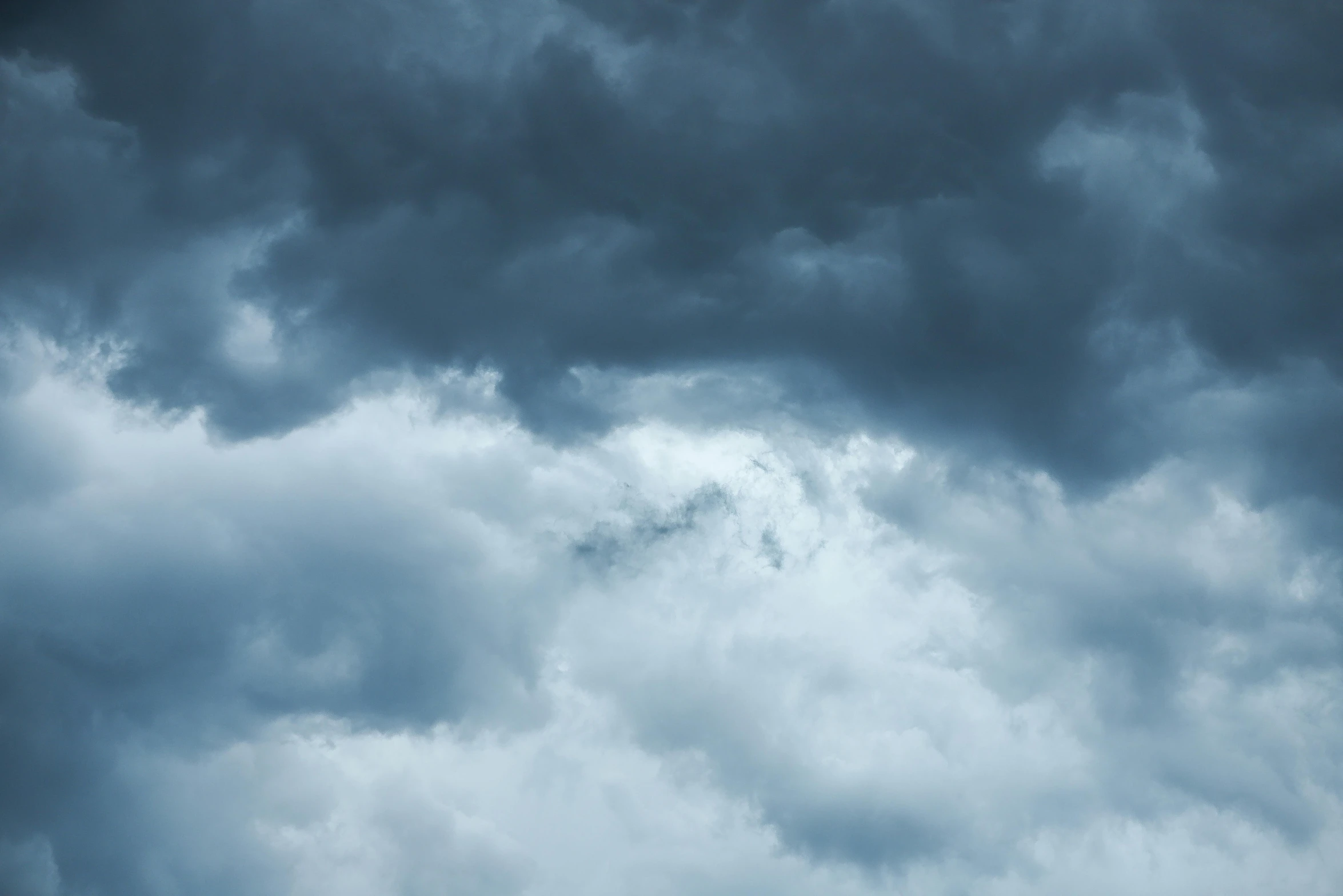 a large jetliner flying through a cloudy sky, an album cover, pexels, romanticism, dark mammatus cloud, soft grey and blue natural light, a close-up, hd footage