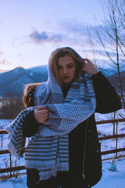 a woman standing in the snow wearing a scarf, a picture, inspired by Elsa Bleda, pexels contest winner, visual art, mountains in the background, teenage girl, pixelated, russian girlfriend