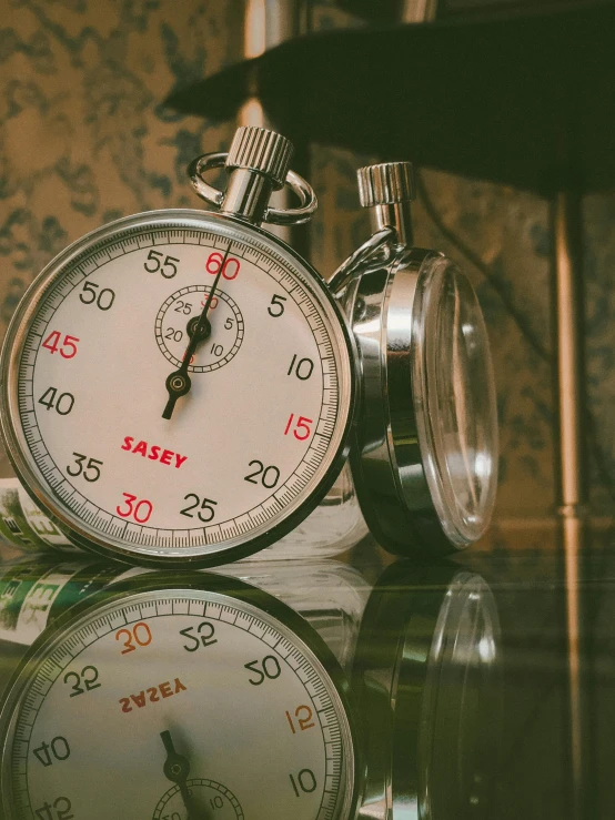 a clock sitting on top of a glass table, by Jessie Algie, pexels contest winner, hyperrealism, vintage race footage, game ready, two exhausted, profile image