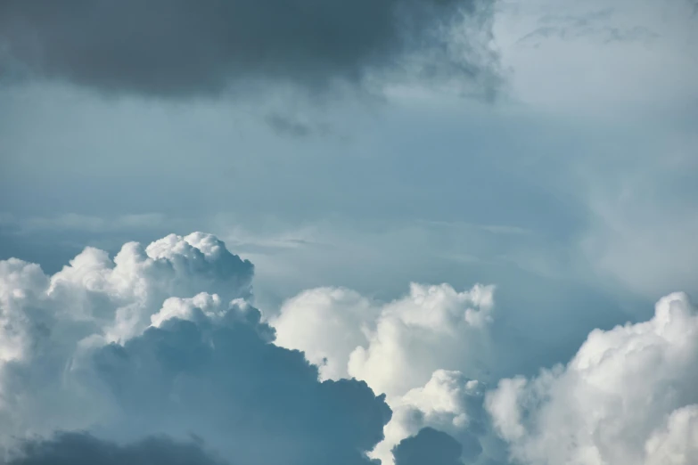 a plane flying through a cloudy blue sky, by Daniel Seghers, unsplash, hyperdetailed storm clouds, layered stratocumulus clouds, today\'s featured photograph 4k, grey