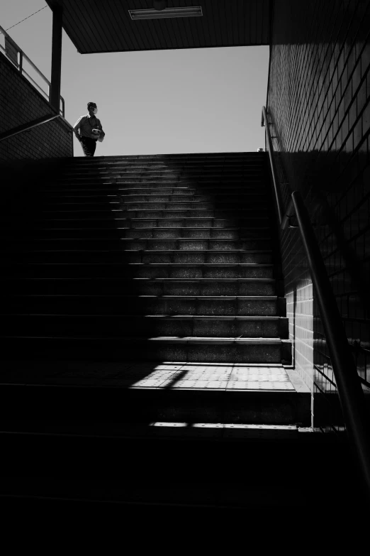 a person sitting on top of a set of stairs, a black and white photo, unsplash, an approaching shadow, in neotokyo, silhouette!!!, 400 steps