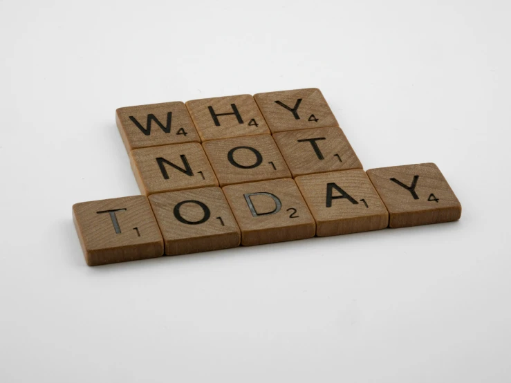 a wooden scrabble with the words why not today written on it, pixabay, graffiti, set against a white background, on grey background, tan, product photograph