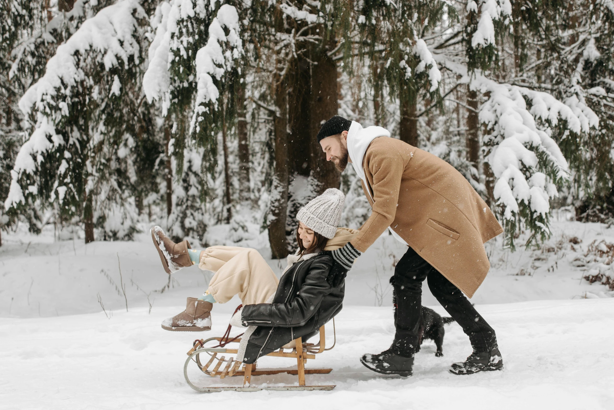 a man pushing a woman on a sled in the snow, pexels contest winner, renaissance, forest picnic, sitting in a rocking chair, profile image, leather clothing and boots