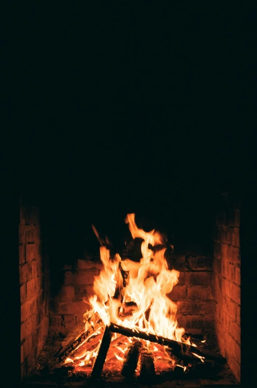 a fire burns in a brick fireplace in the dark, an album cover, pexels, winter vibes, warm summer nights, ios, devils