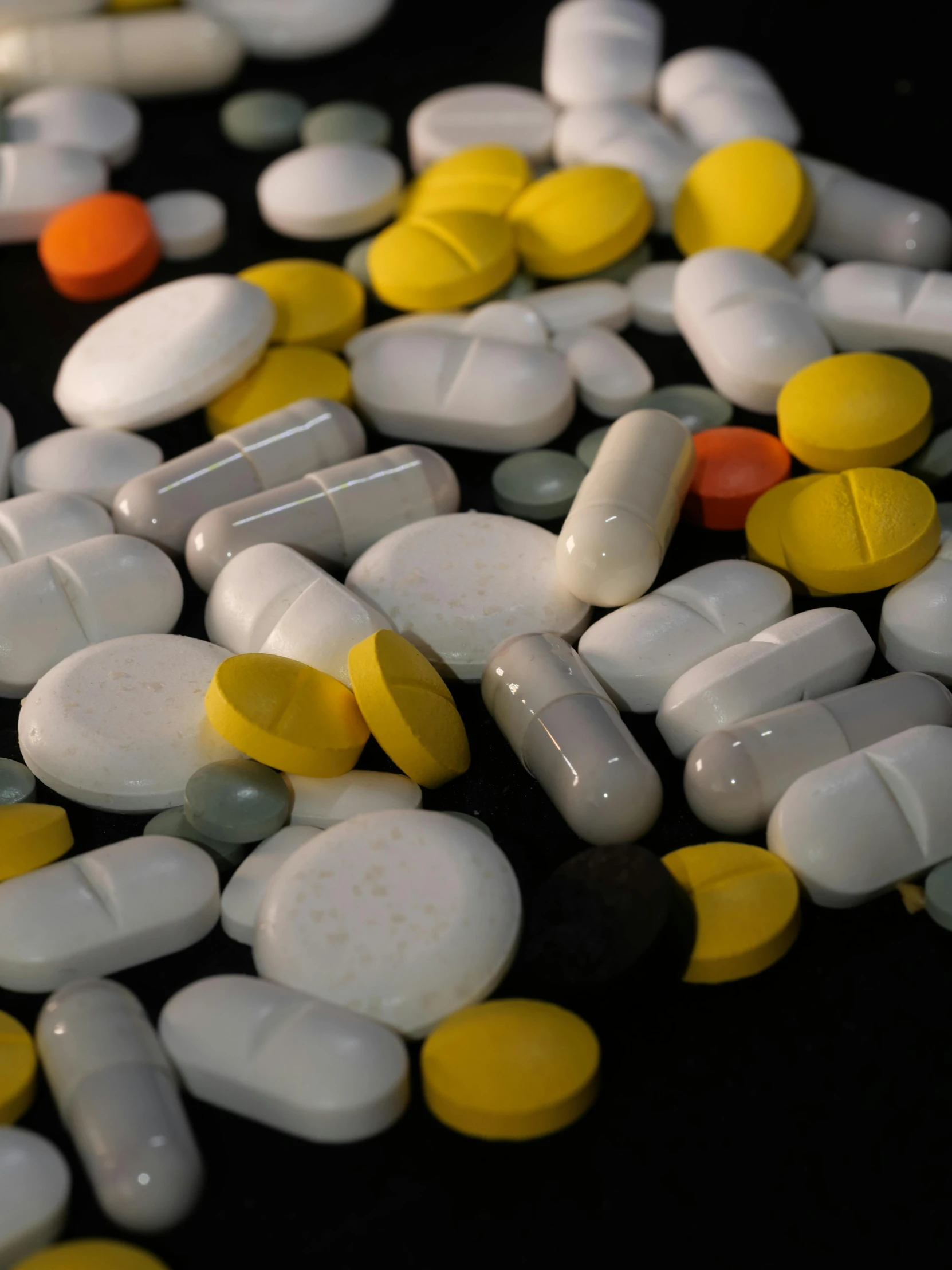 a pile of pills sitting on top of a table, by Greg Rutkowski, plasticien, on a black background, multiple stories, colorful medical equipment, full frame image