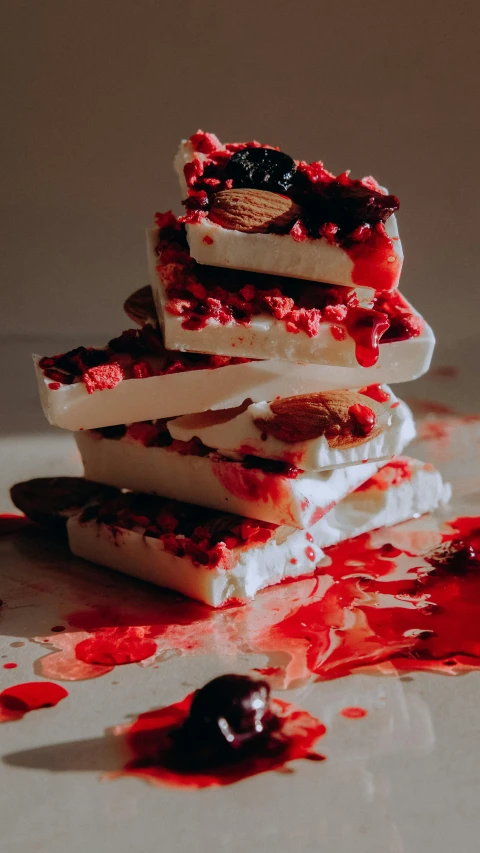 a close up of a piece of food on a table, by Nick Fudge, pexels, process art, crimson and white color scheme, candies, tall, 15081959 21121991 01012000 4k