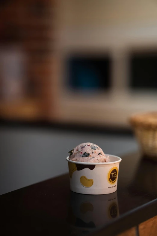 a bowl of ice cream sitting on top of a counter, cinematic shot ar 9:16 -n 6 -g, detailed product image, blueberry, small