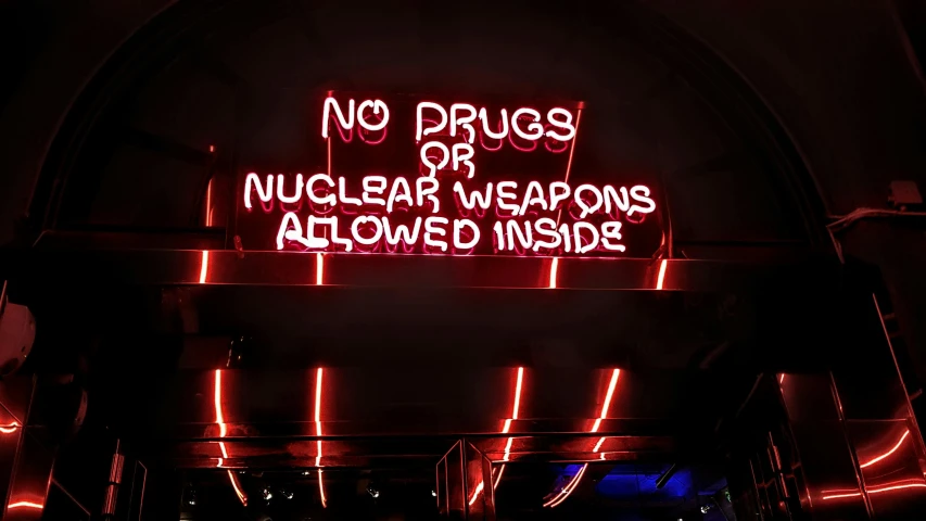 a neon sign that says no drugs or nuclear weapons allowed inside, by Julia Pishtar, pexels, 💋 💄 👠 👗, handguns, a 1980s goth nightclub in soho, makeshift weapons