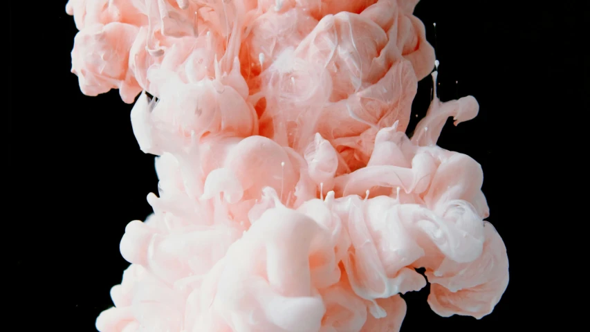 a close up of a pink substance on a black background, inspired by Alberto Seveso, trending on pexels, creamy, teamlab, made of cotton candy, flowing salmon-colored silk