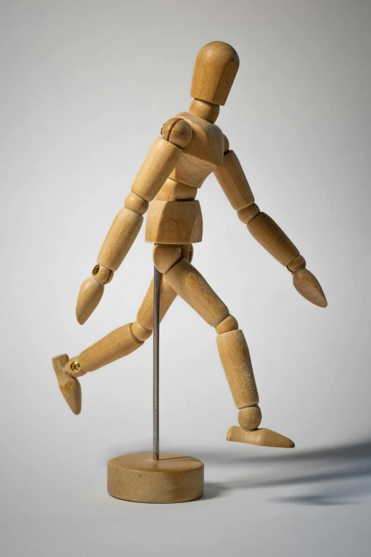 a wooden mannequin standing on a wooden base, by David Simpson, visual art, running freely, art toys on feet, no - text no - logo, one legged amputee