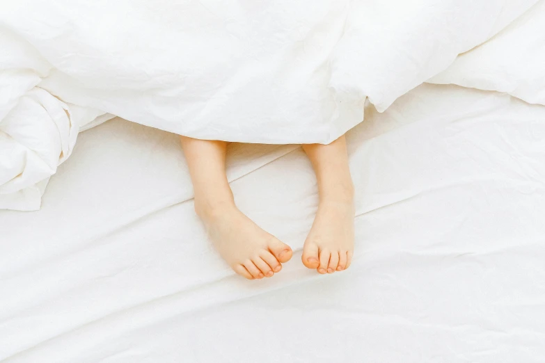 a person laying in bed under a white blanket, little kid, exposed toes, thumbnail, rectangle