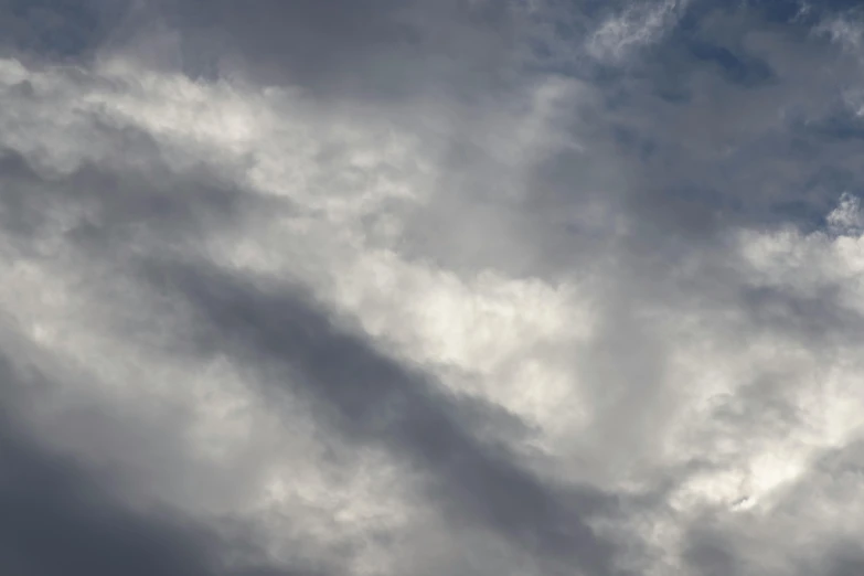 a large jetliner flying through a cloudy sky, an album cover, by Linda Sutton, unsplash, lyrical abstraction, closeup photograph, layered stratocumulus clouds, today\'s featured photograph 4k, grey