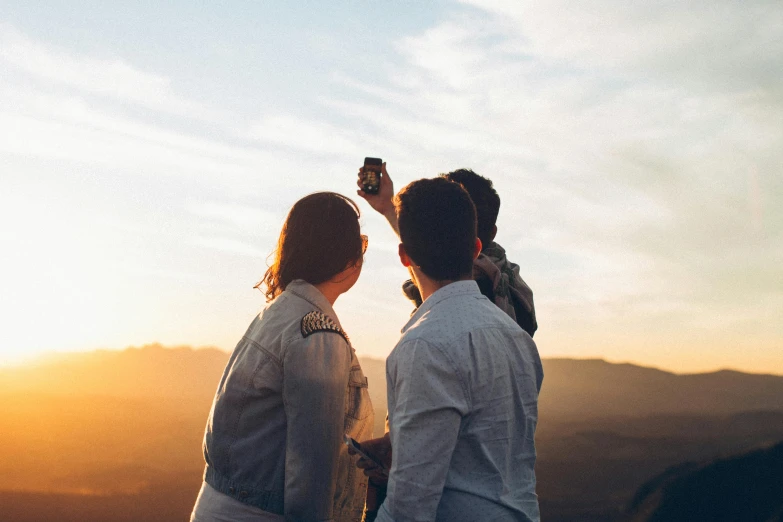 a group of people standing on top of a mountain, pexels contest winner, in love selfie, profile image, warm glow, al fresco