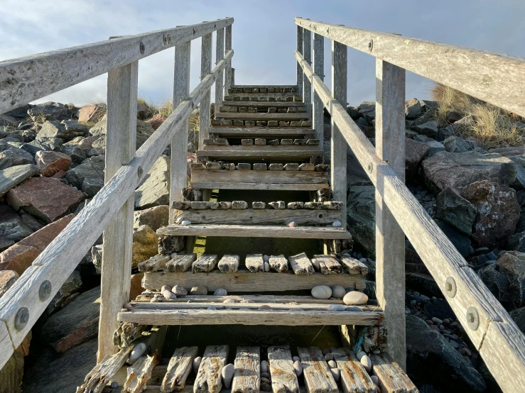 a set of stairs leading to the top of a mountain, unsplash, realism, rock pools, wooden structures, barnacle, 2022 photograph