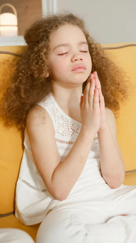 a little girl sitting on a couch with her eyes closed, pexels, renaissance, praying posture, with afro, portrait of white teenage girl, 15081959 21121991 01012000 4k