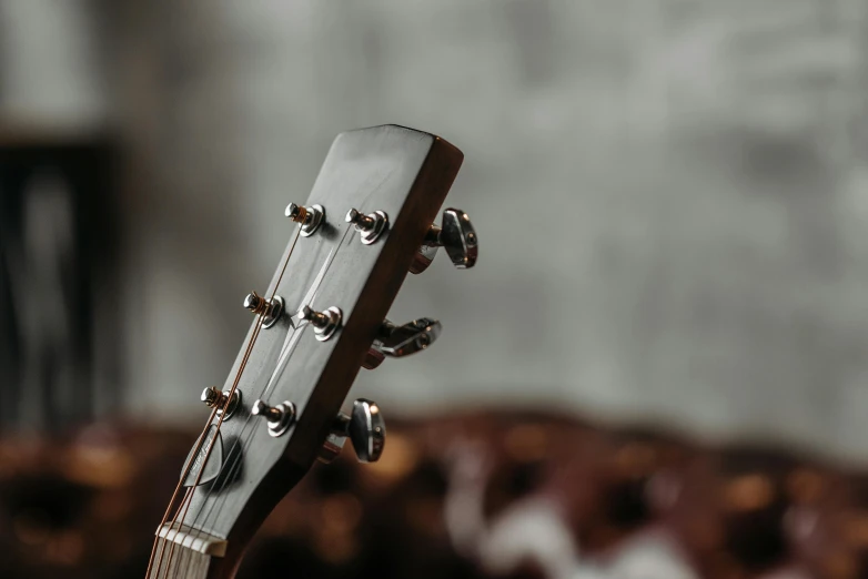 a close up of a guitar on a table, by Carey Morris, pexels contest winner, neck zoomed in, plain background, valves, thumbnail