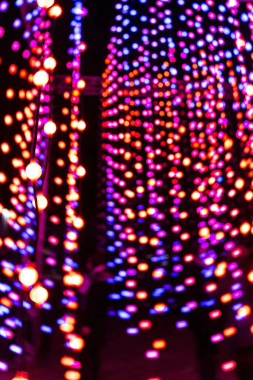 colorful lights are lit up in the dark, a picture, inspired by Bruce Munro, flickr, kinetic pointillism, ✨🕌🌙, some red and purple, light leaks, cozy lights