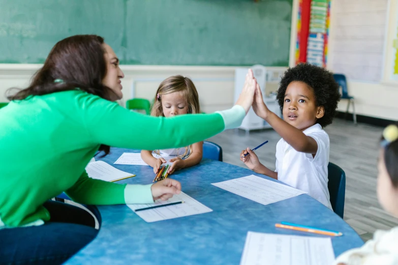 a teacher giving a high five to a group of children, pexels contest winner, american barbizon school, group sit at table, 15081959 21121991 01012000 4k, instagram post, diverse