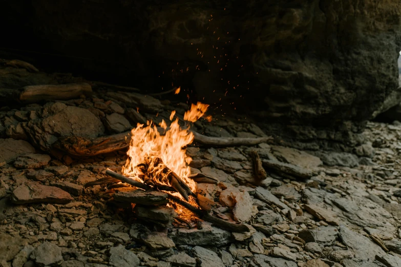 a campfire in the middle of a rocky area, pexels contest winner, visual art, warm wood, profile image, bushfire, subtle detailing