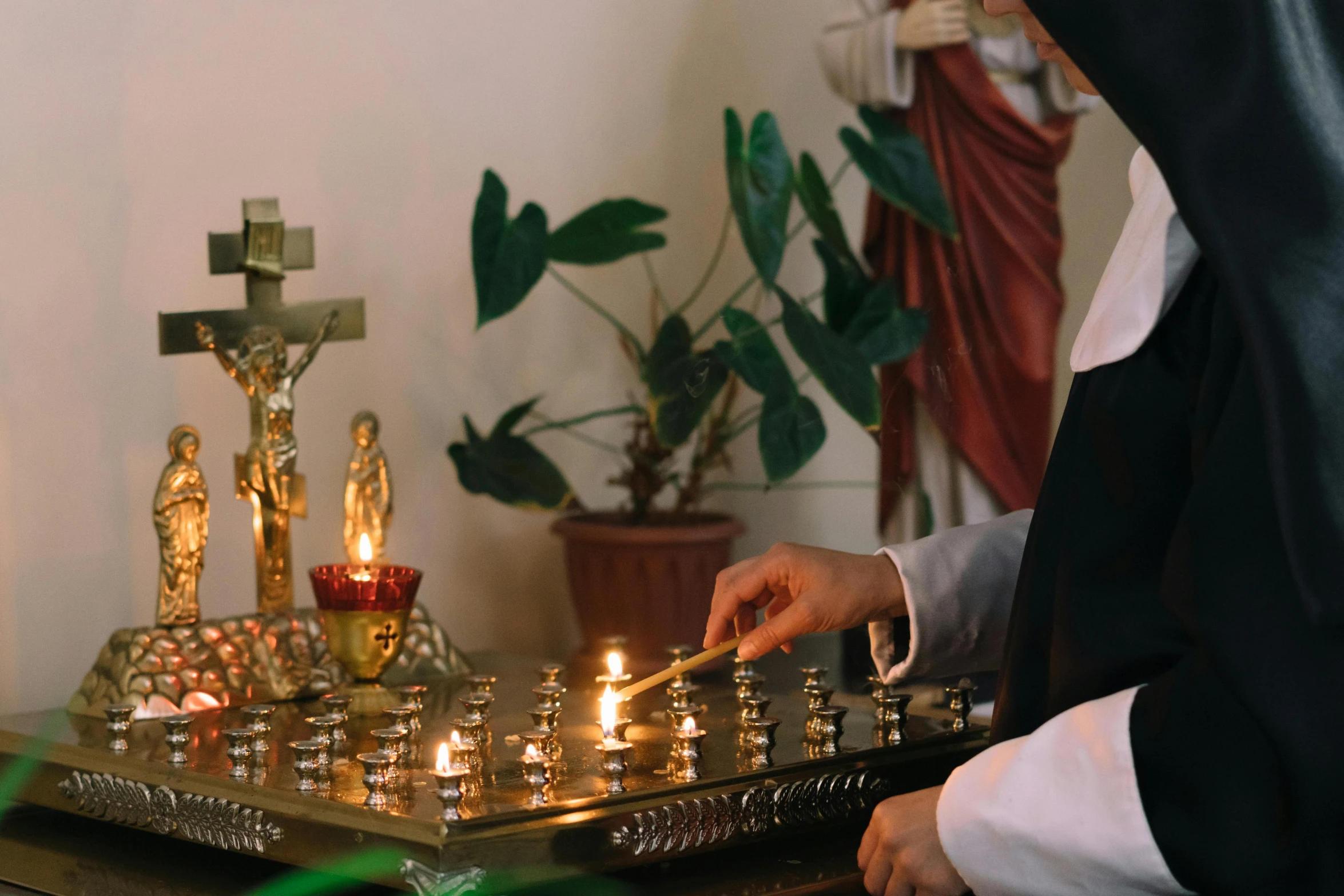 a couple of people that are playing a game of chess, pexels, visual art, catholic icon, holding a candle holder, nun, standing in front of the altar