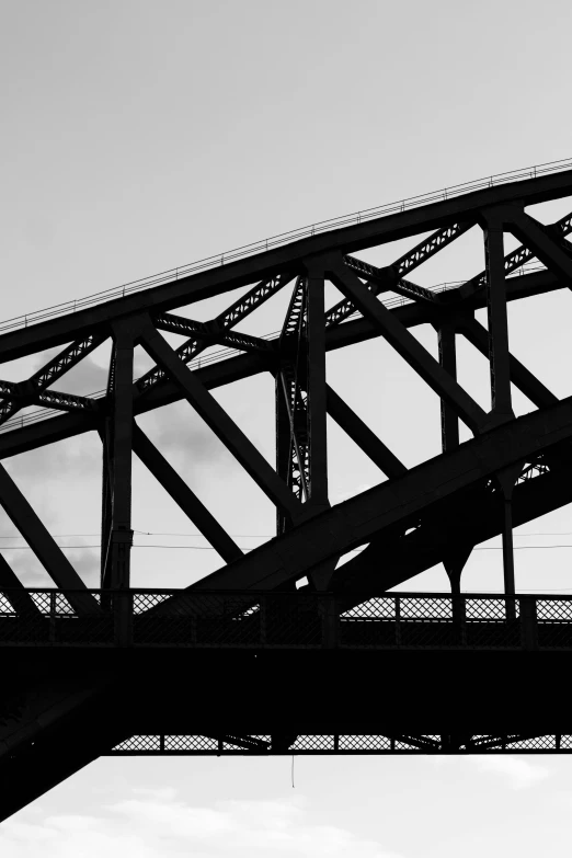 a black and white photo of a bridge, precisionism, in chippendale sydney, silhouette :7, made of steel, photos