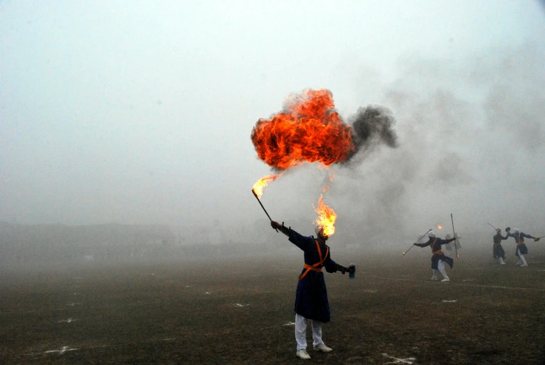 a man standing on top of a field holding a fire, inspired by Zhang Kechun, pexels contest winner, visual art, olympics ceremony, wielding a fireball, performing to dead soldiers, sha xi